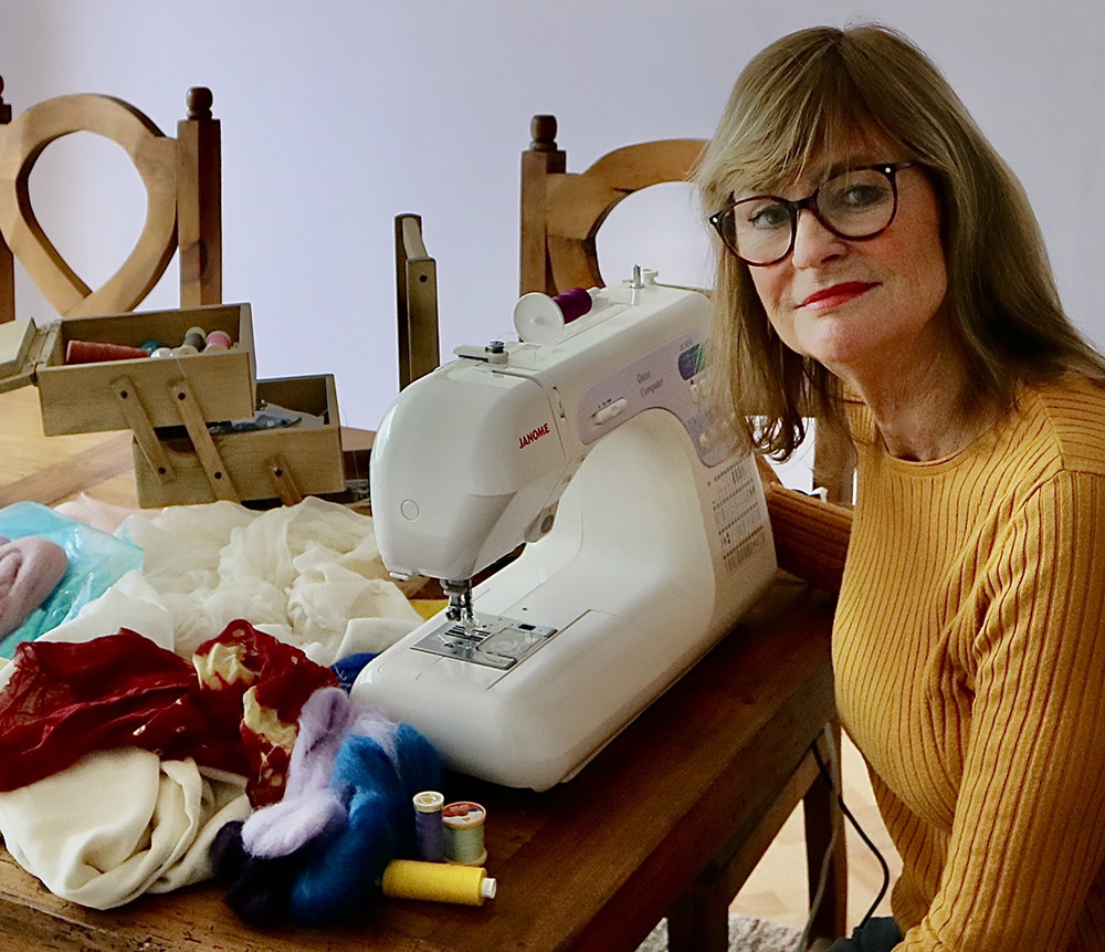 An image of Gill Swanson working at her sewing machine